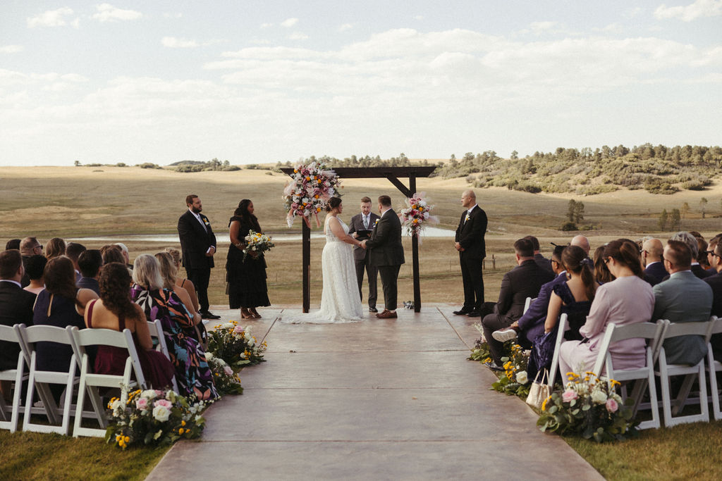 An early Fall outdoor wedding ceremony at Flying Horse Ranch near Colorado Springs, Colorado