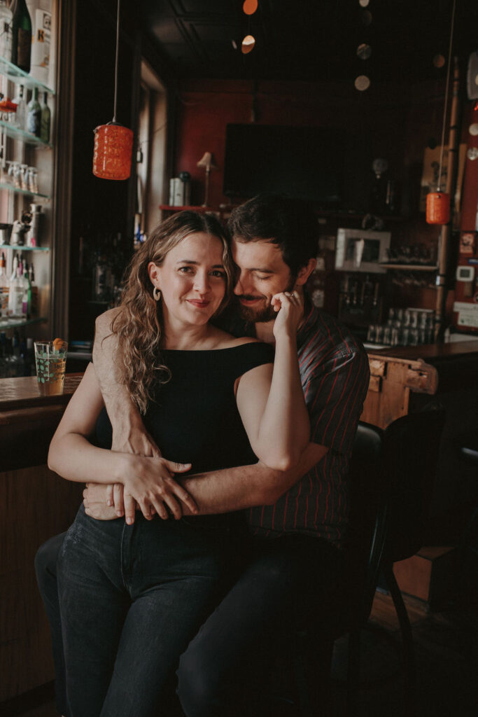 Creative cozy engagement photos at a bar in downtown Cleveland, OH.